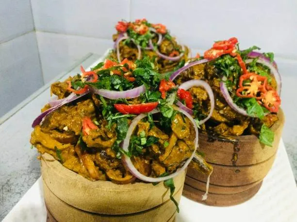 Traditional Eastern Nigerian recipe prepared with Goat meat, spices, seasonings, vegetables and palm oil
