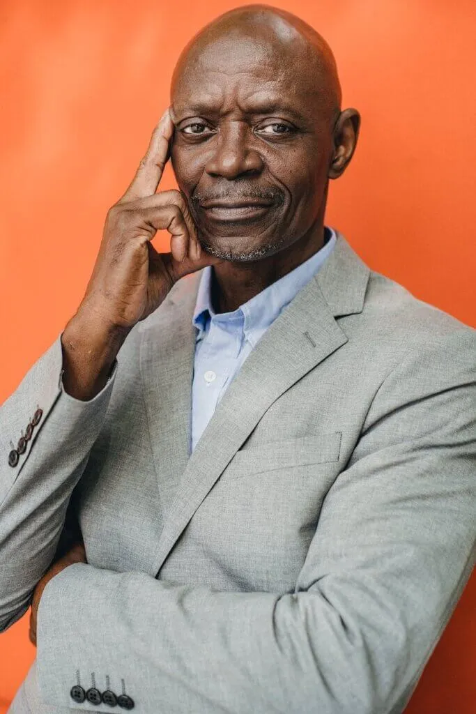 Who Is The Owner Of The MTN? 1 intelligent black businessman in suit on orange background