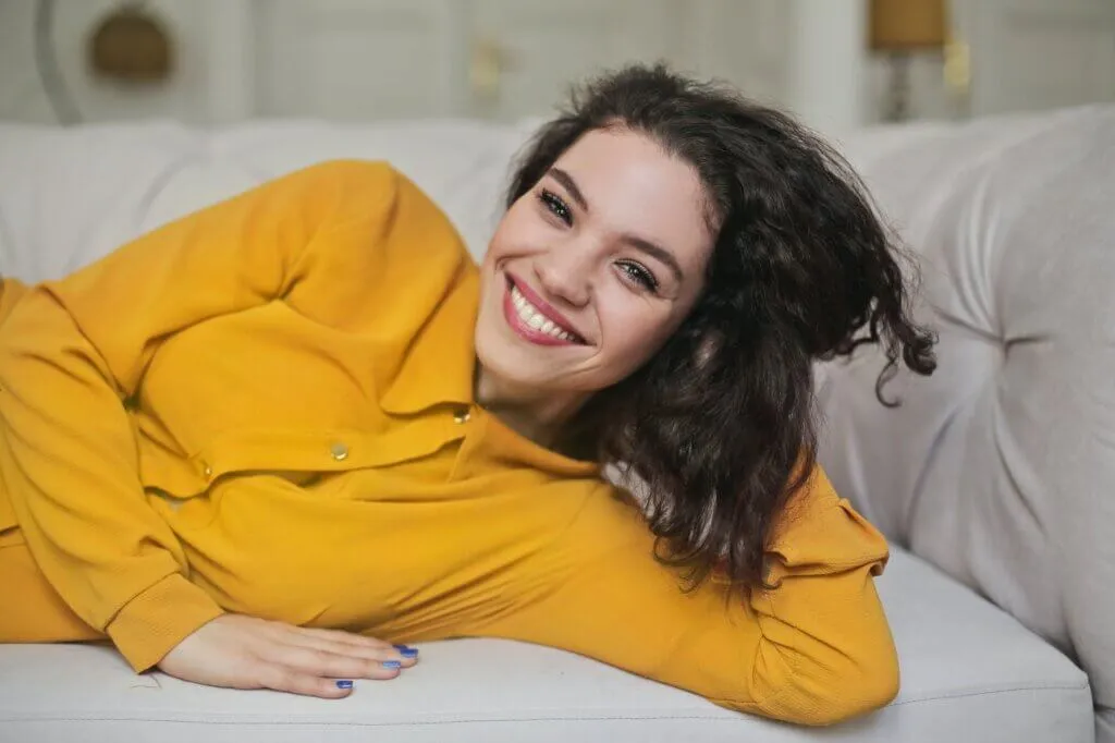 woman in yellow button up top