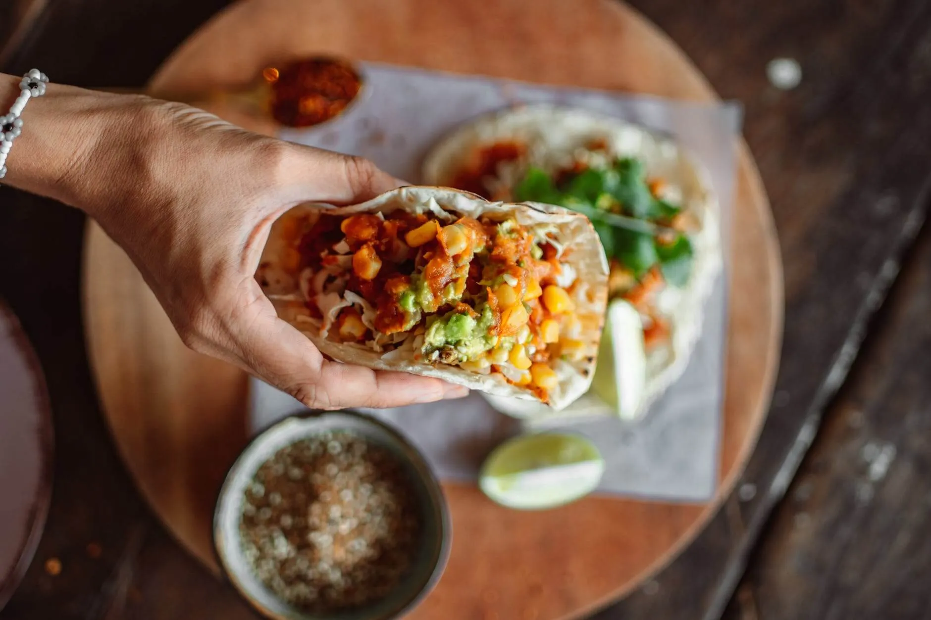 a person holding a taco