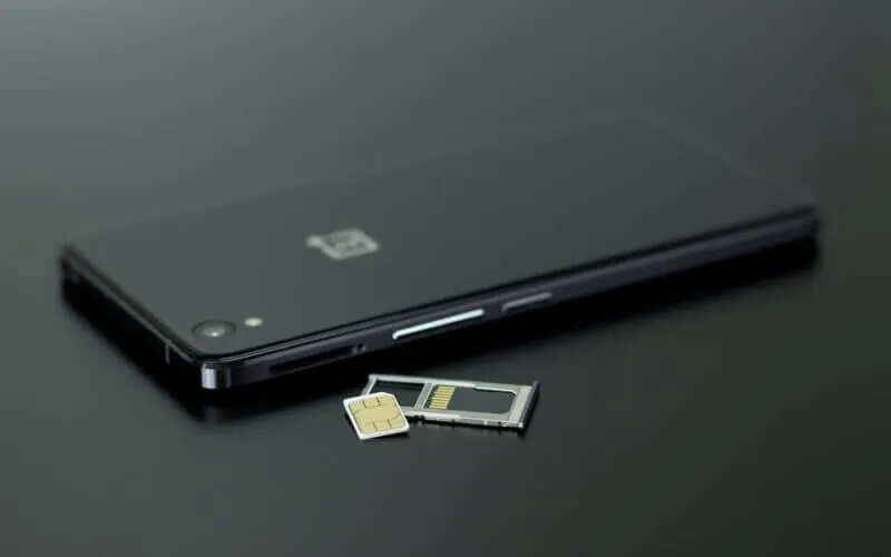 black smartphone on black table top