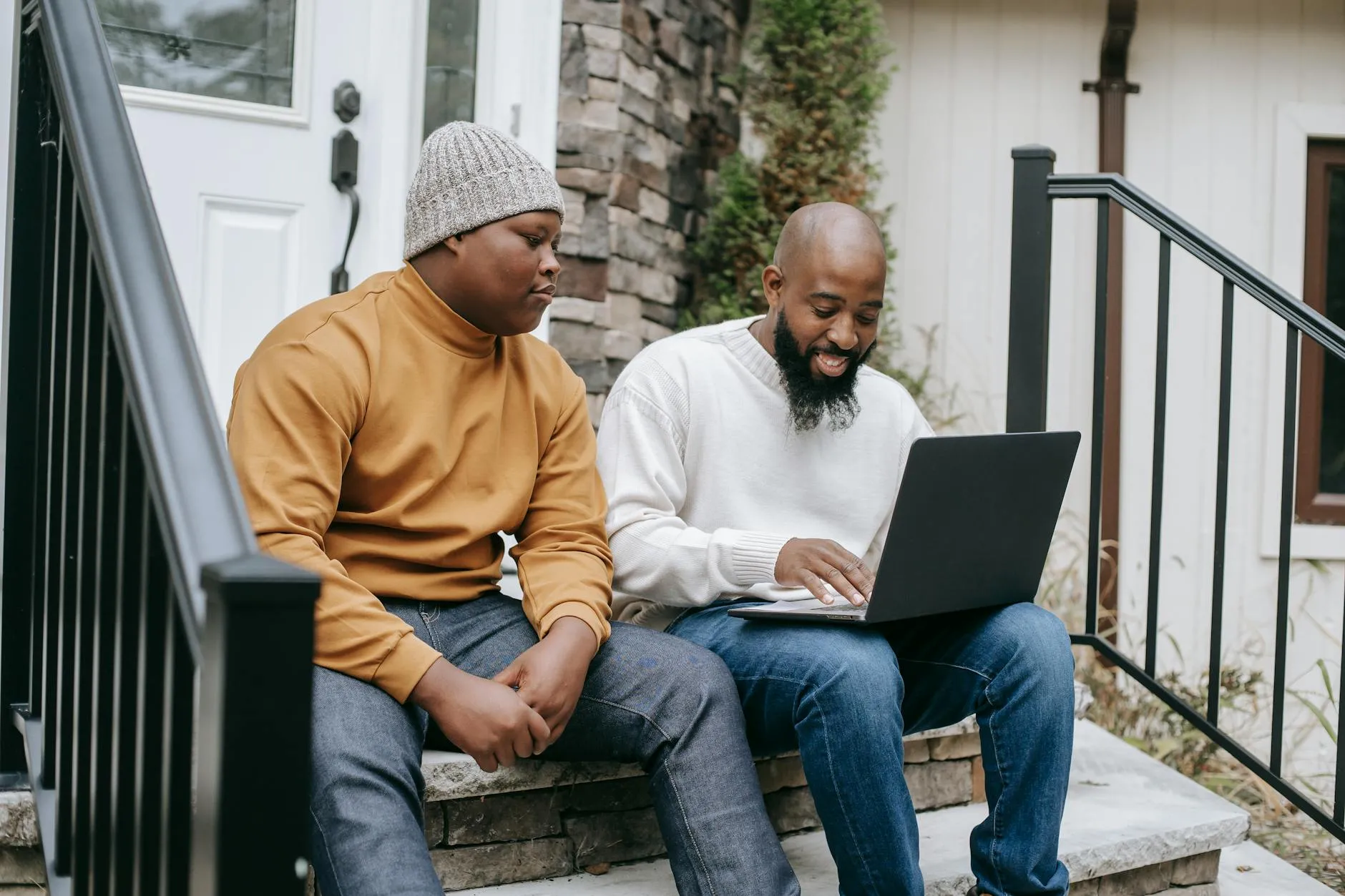 Digital Nomads working cheerful Remote Workers In Scotland browsing laptop with son