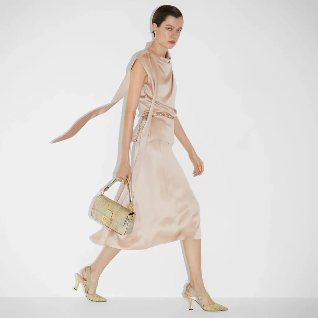 Top 10 expensive luxury bags for ladies 4 A model holding an expensive handbag for women- Fendi Florentine Paper Bag