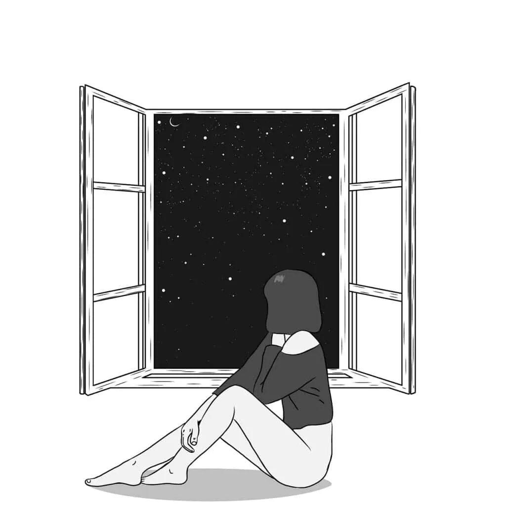 A woman sitting by a window and looking out