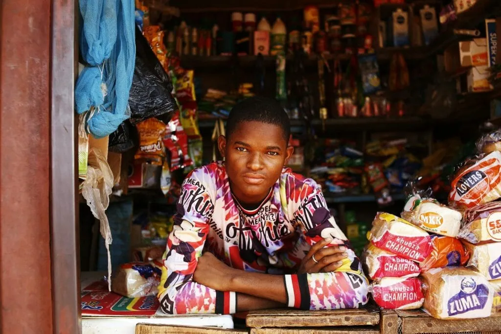 young shopkeeper in abuja market